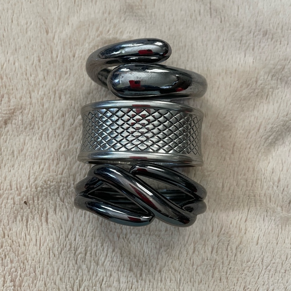 3 spring hinged bangles 1 is Lia Sophia